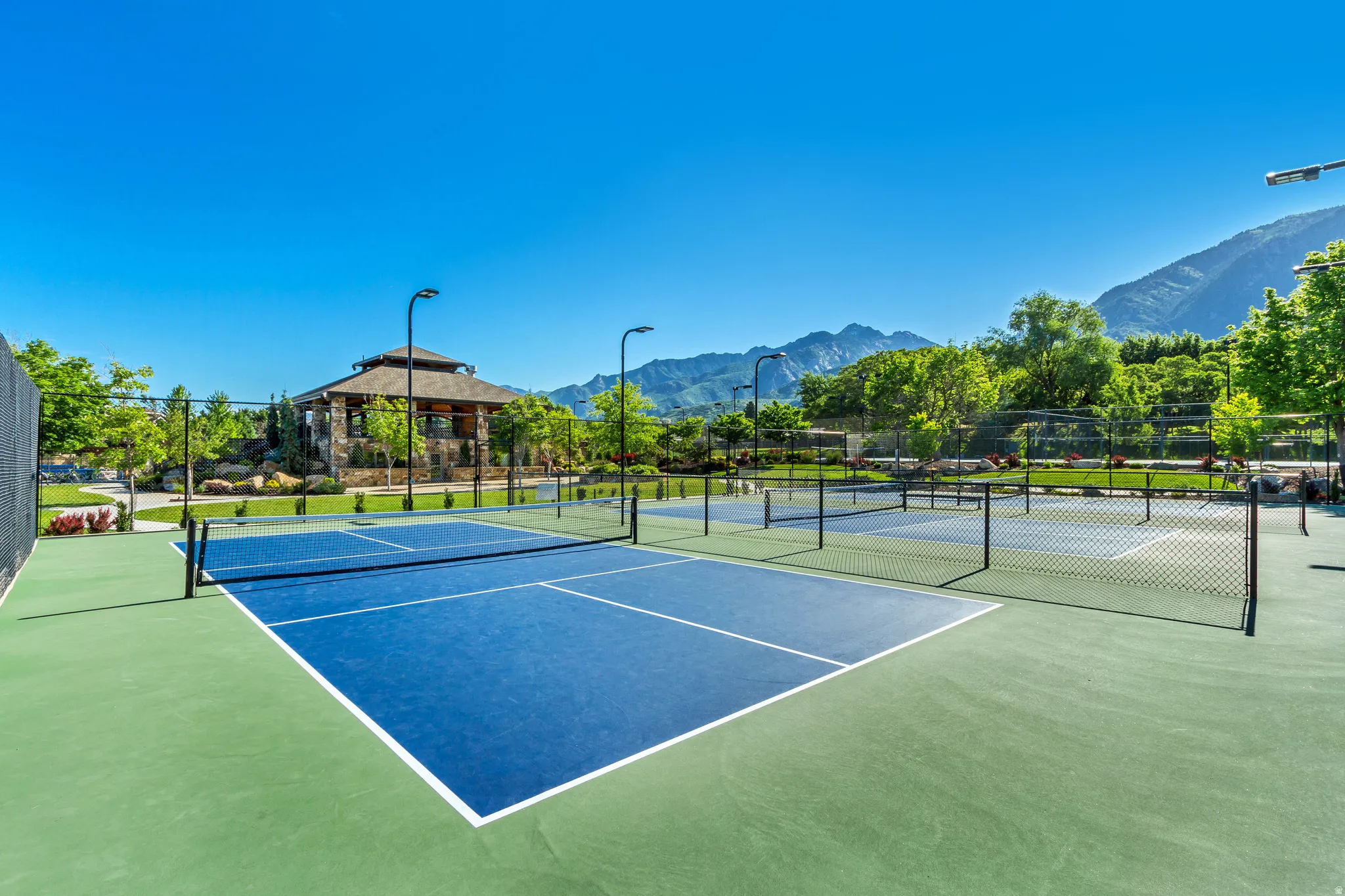 View of tennis court with a mountain view