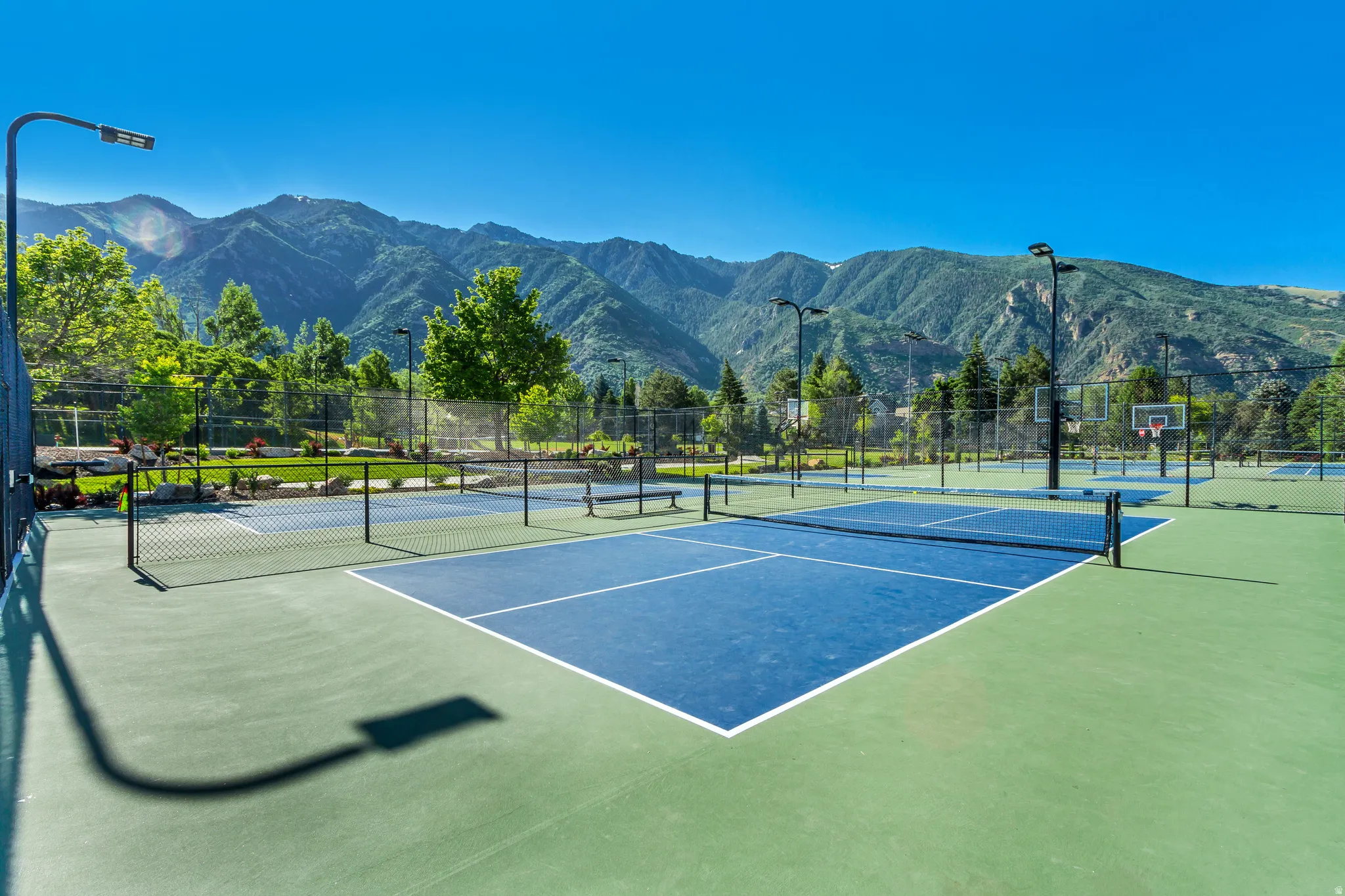 View of tennis court with a mountain view