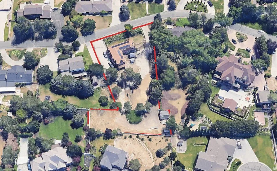 Aerial view of residential area with property boundaries highlighted