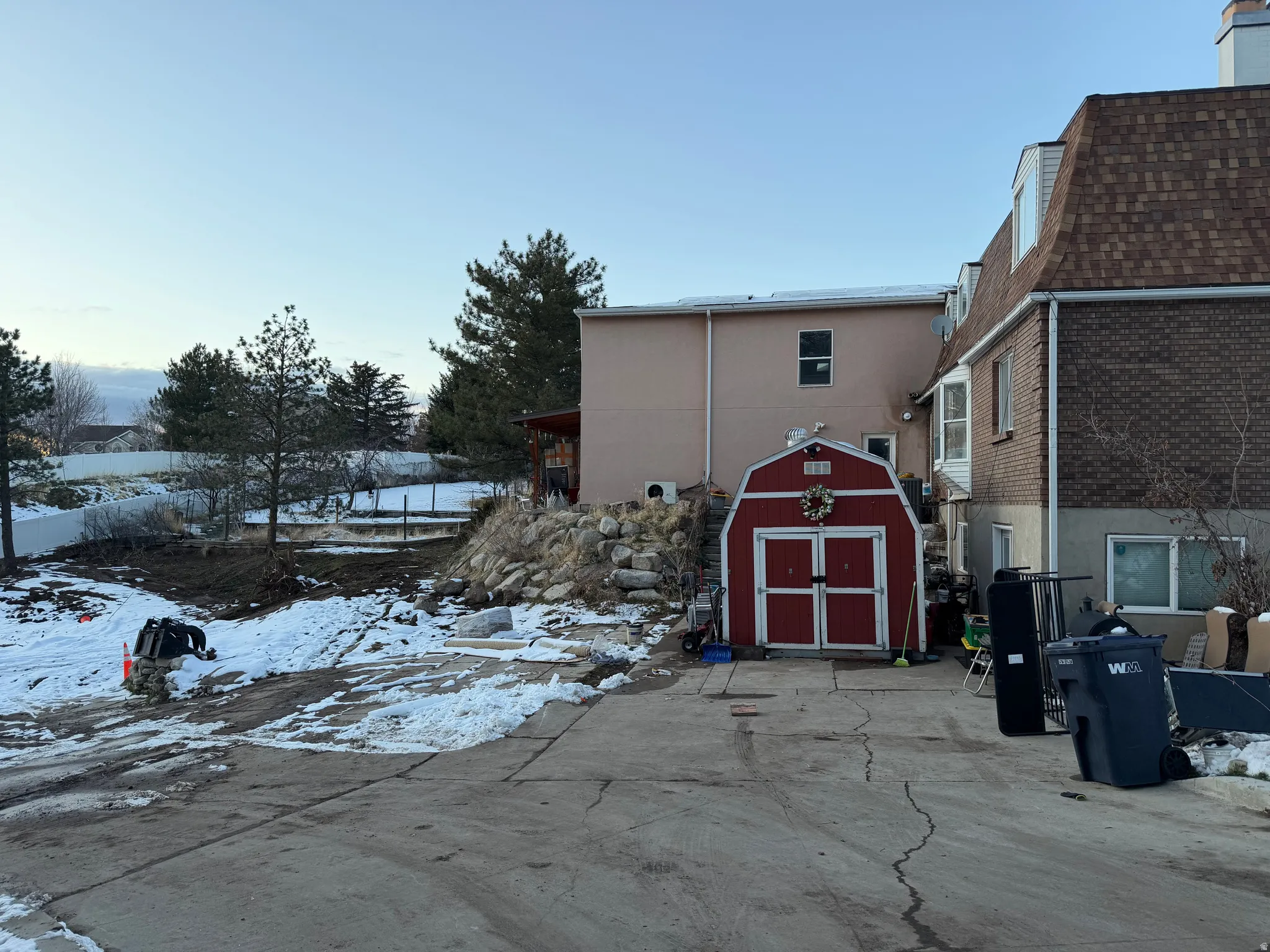 Snow covered property featuring a storage shed