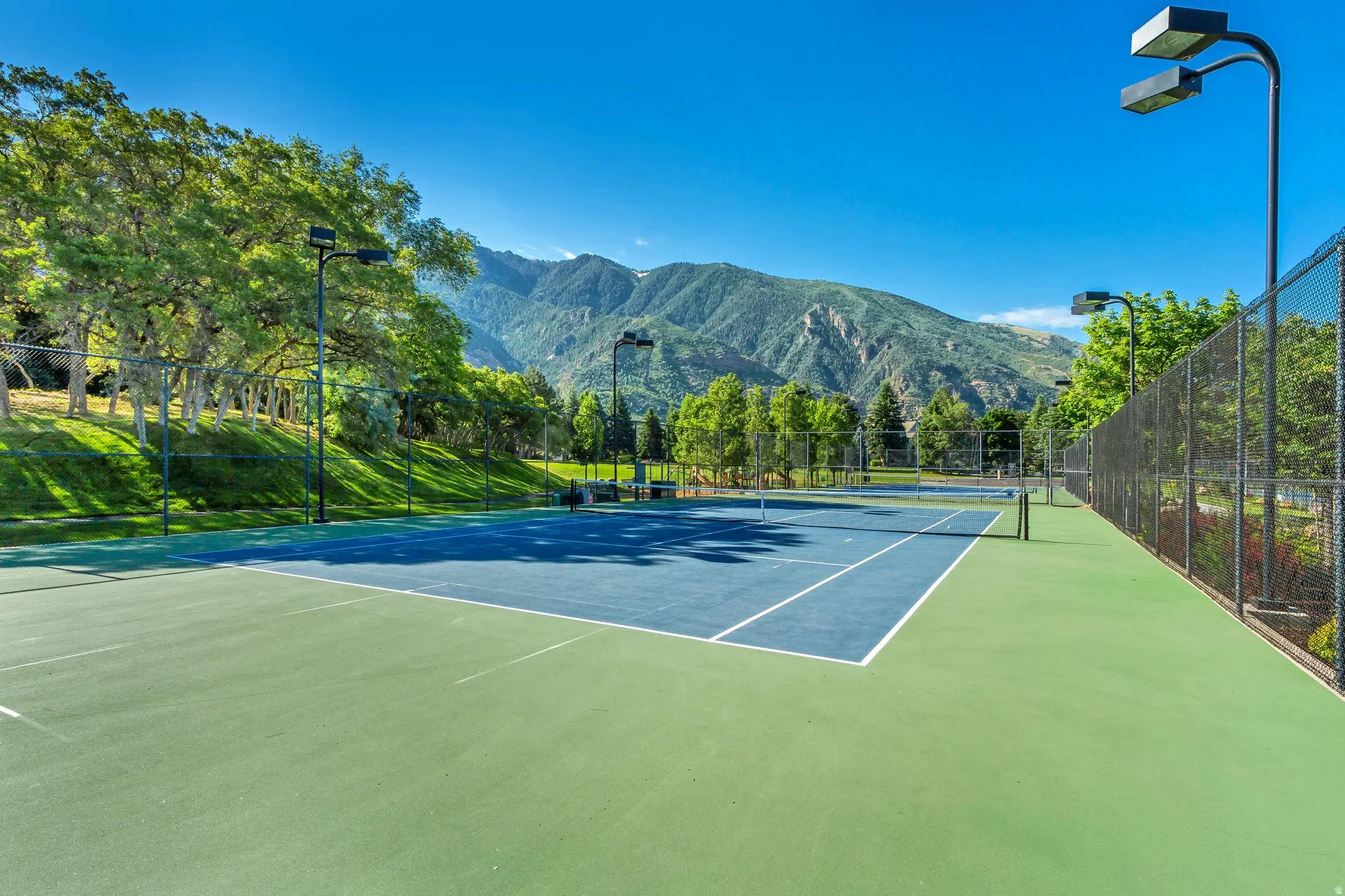 View of tennis court with a mountain view