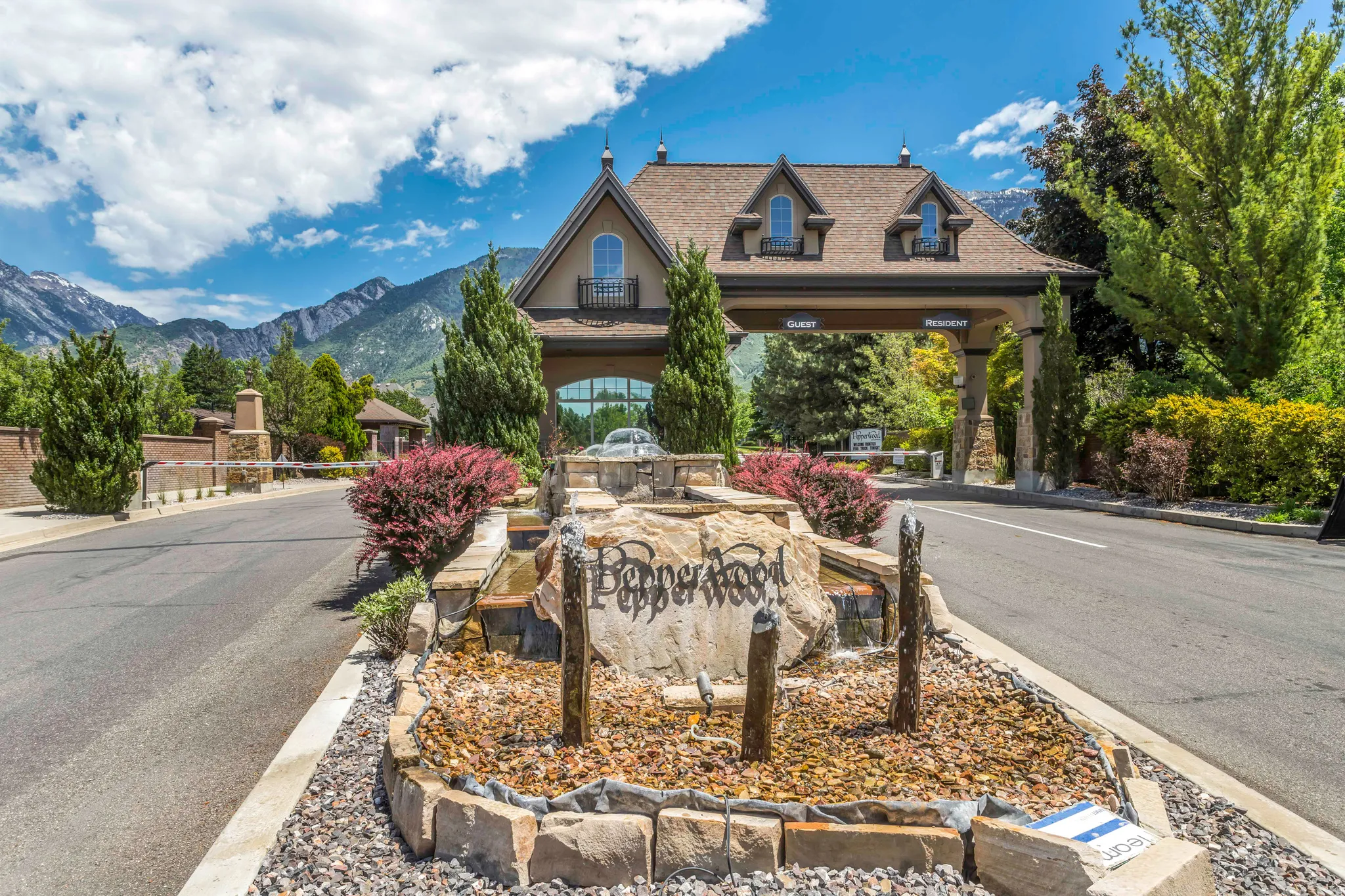 View of asphalt road featuring curbs and a mountain view