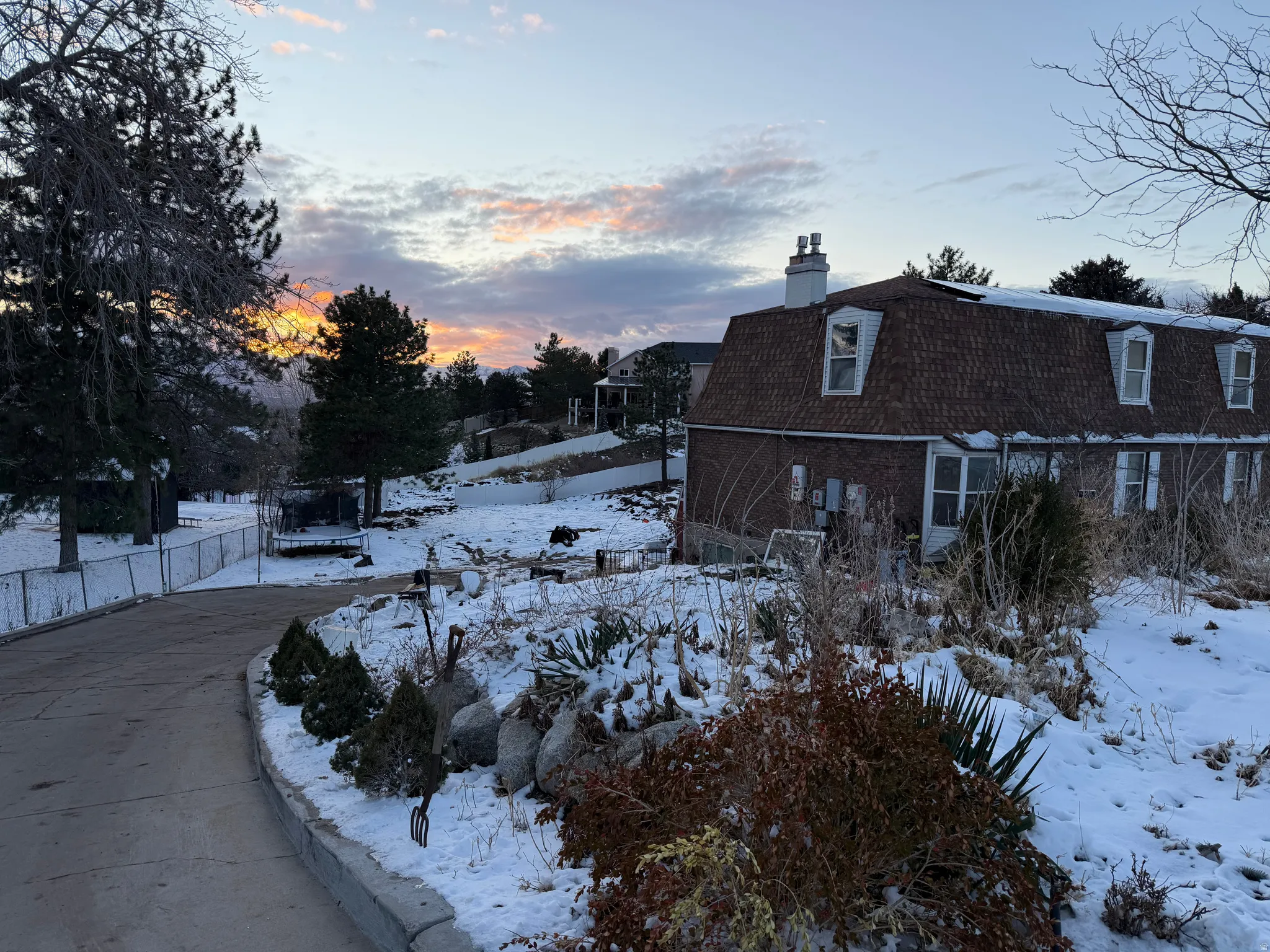View of snowy exterior with a chimney