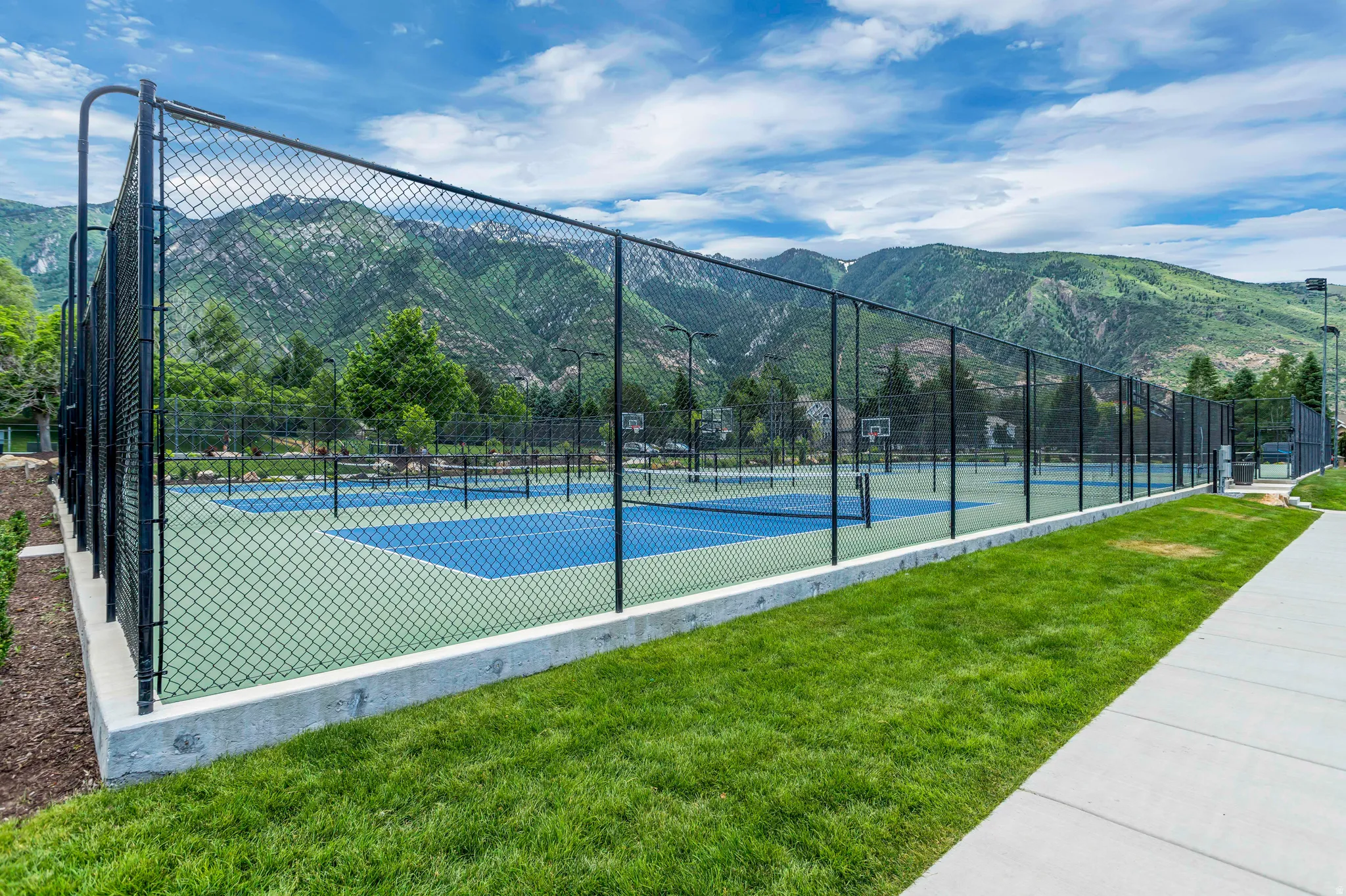 View of tennis court with a mountain view