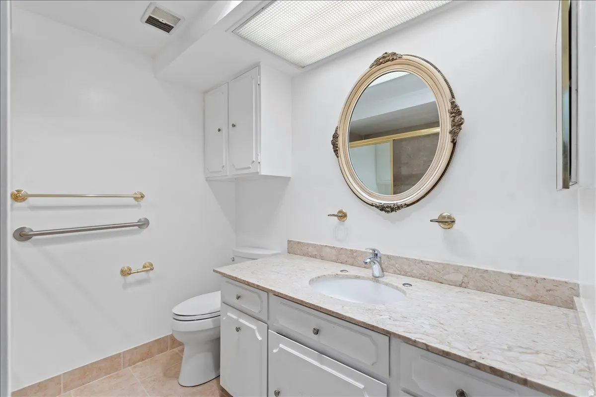 Bathroom featuring vanity and light tile patterned floors