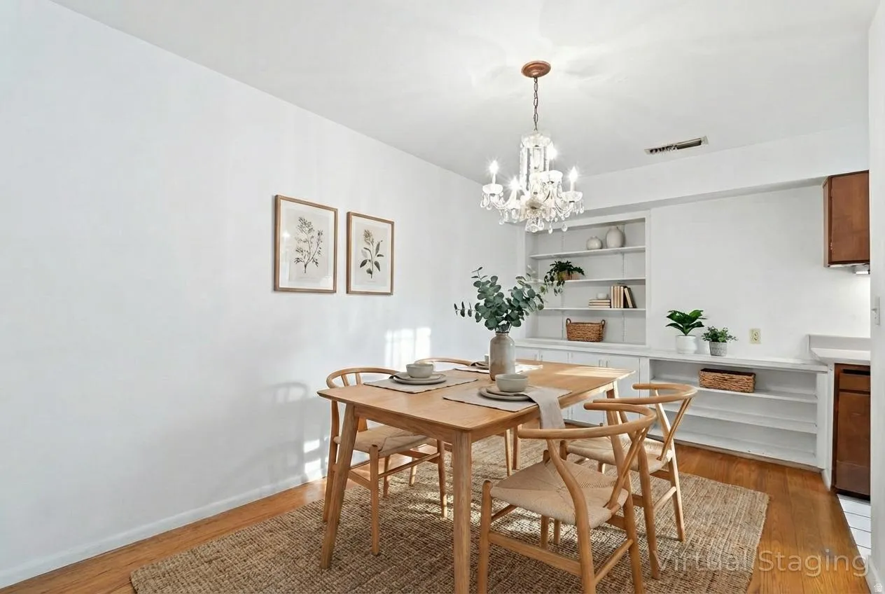 Dining area featuring wood-finish flooring and a crystal chandelier
