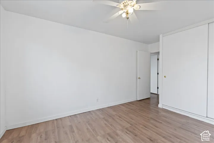 Bedroom with a ceiling fan and wood finished floors