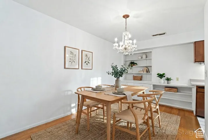 Dining area featuring wood-finish flooring and a crystal chandelier