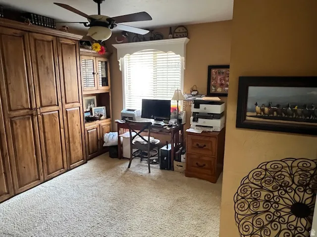 Office space featuring light colored carpet and ceiling fan