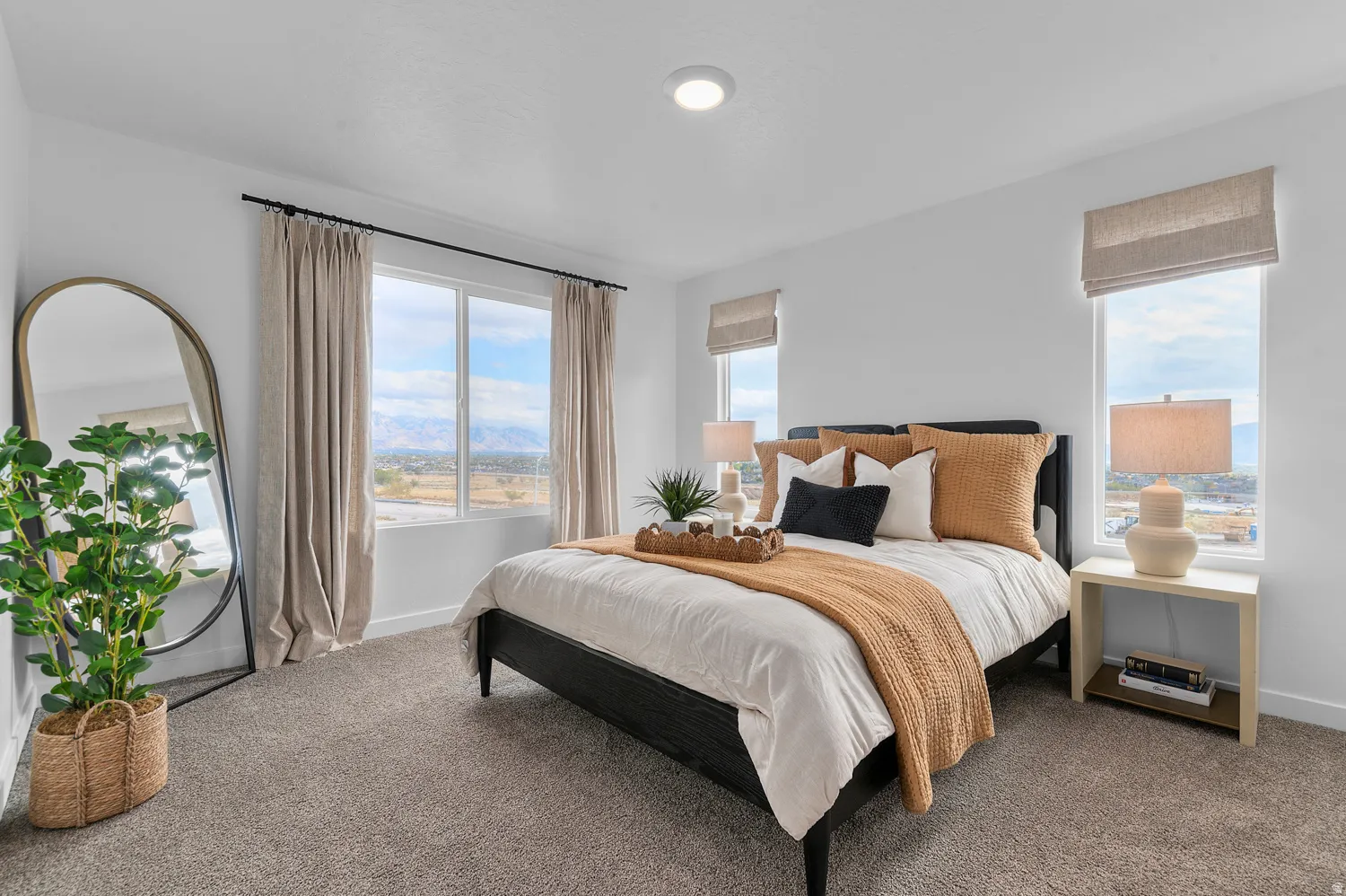 Carpeted bedroom featuring multiple windows and a mountain view