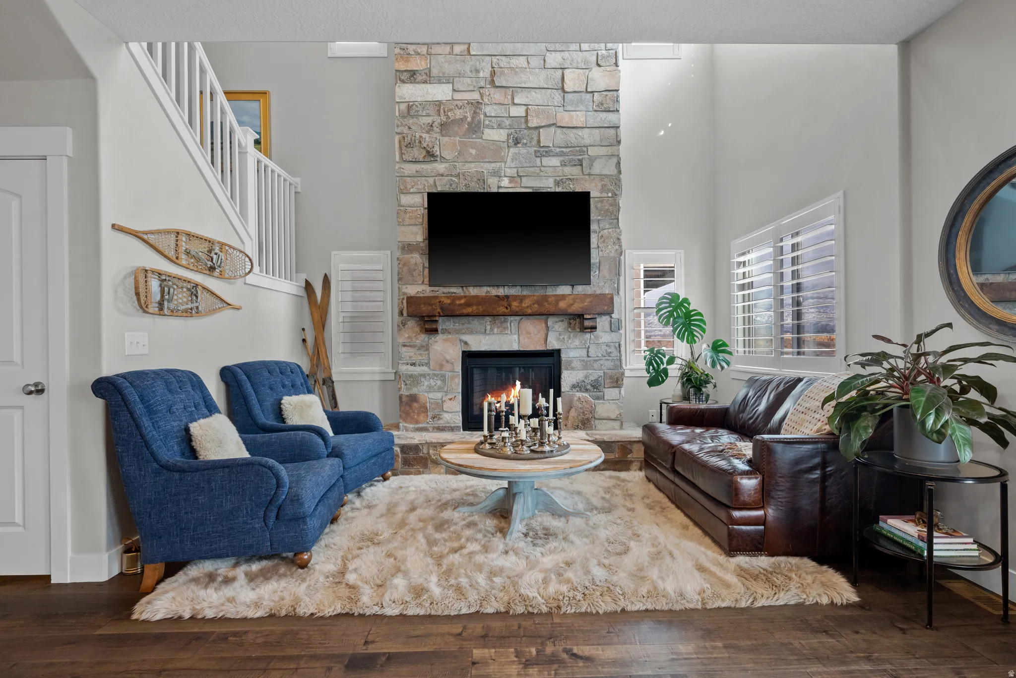 Living room with natural stone gas fireplace, open to upper floor