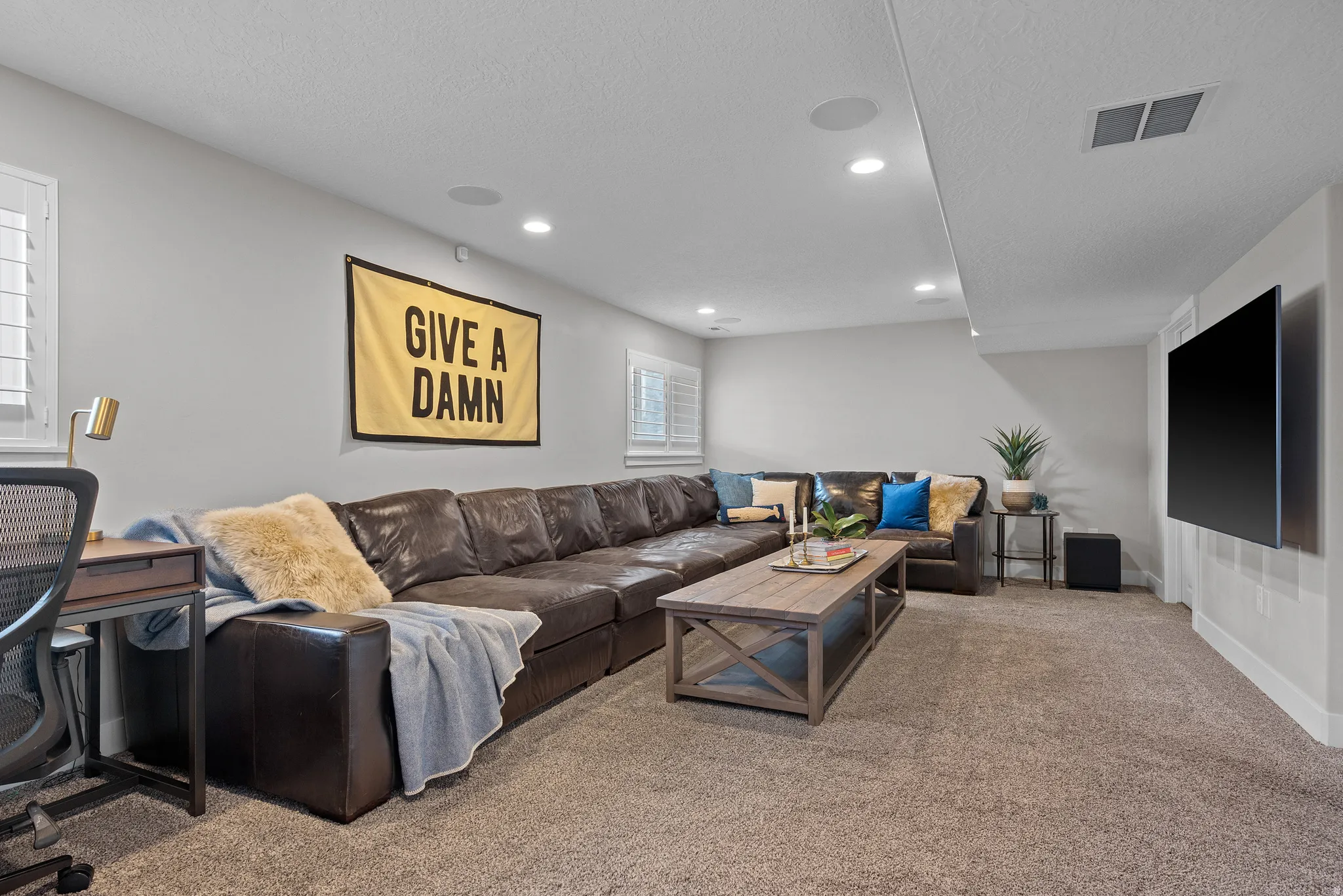 Inviting family room with built in Speakers, and amazing storage for games and activities