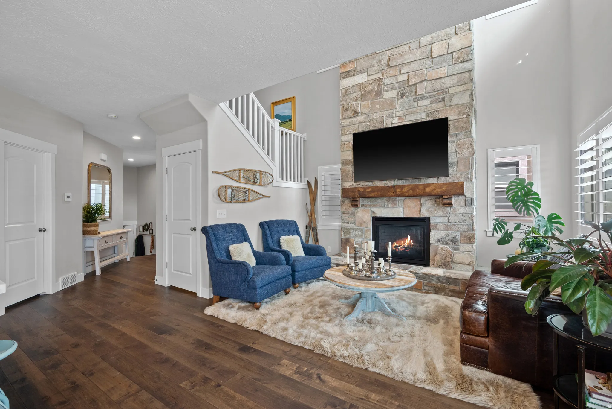 Living room featuring dark wood finished floors, a fireplace, and a textured ceiling