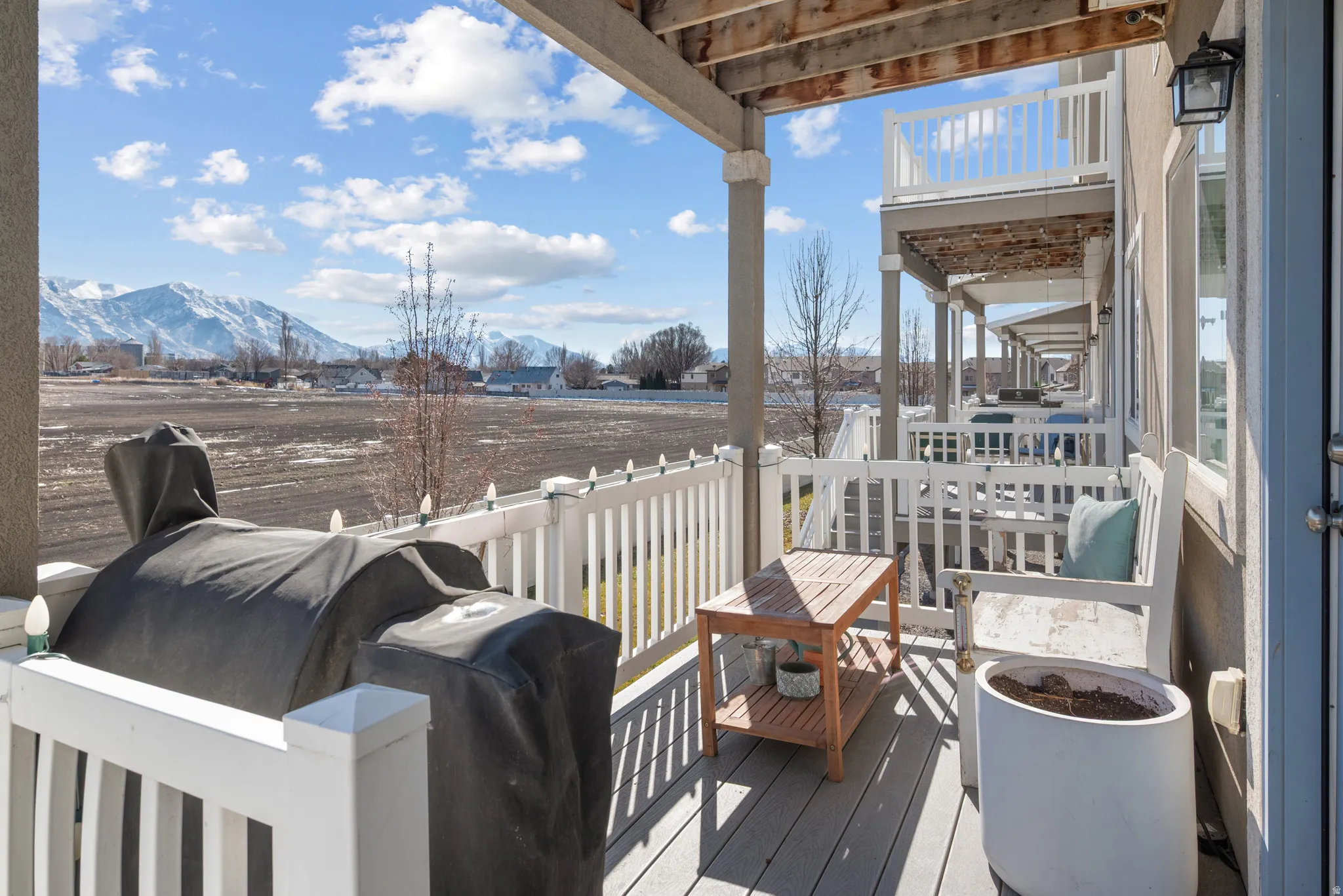 Deck featuring a beautiful view of the Wasatch front,  large enough for BBQing, or relaxing with a good book, relaxing on some comfortable outdoor furniture.