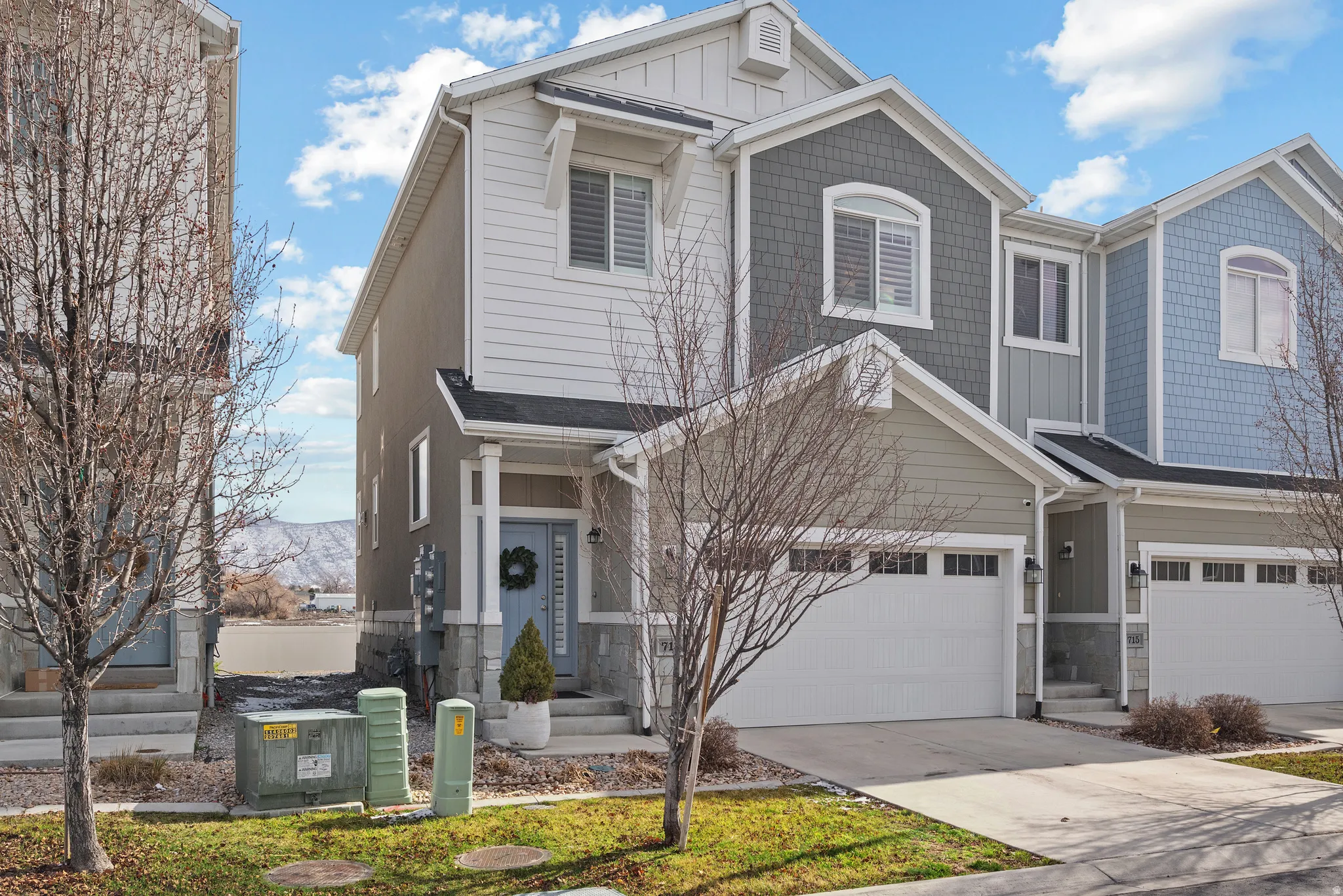 View of front of house featuring board and batten siding, concrete driveway, and an attached garage