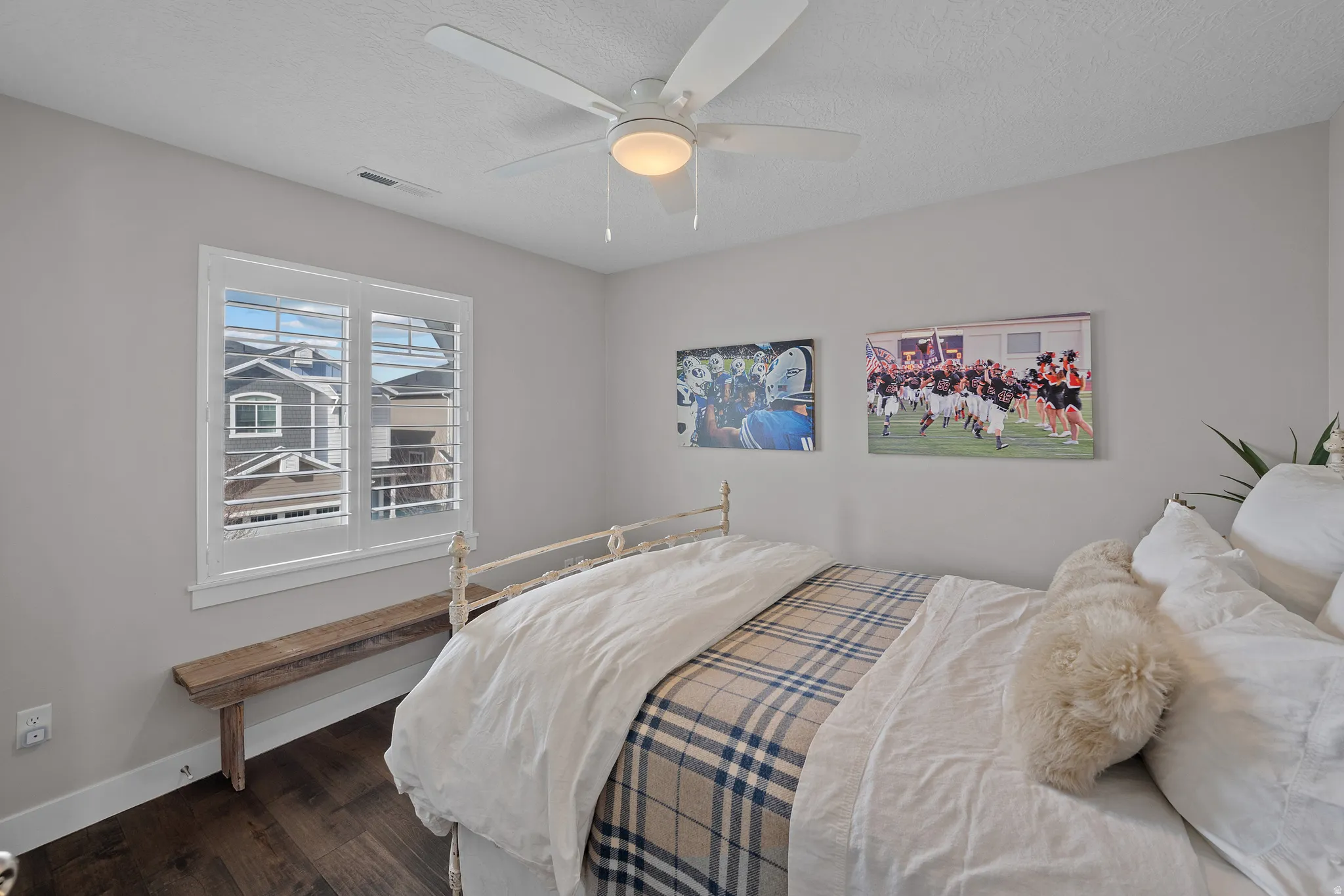 Bedroom 2, same beautiful hardwood with a ceiling fan, and custom closet