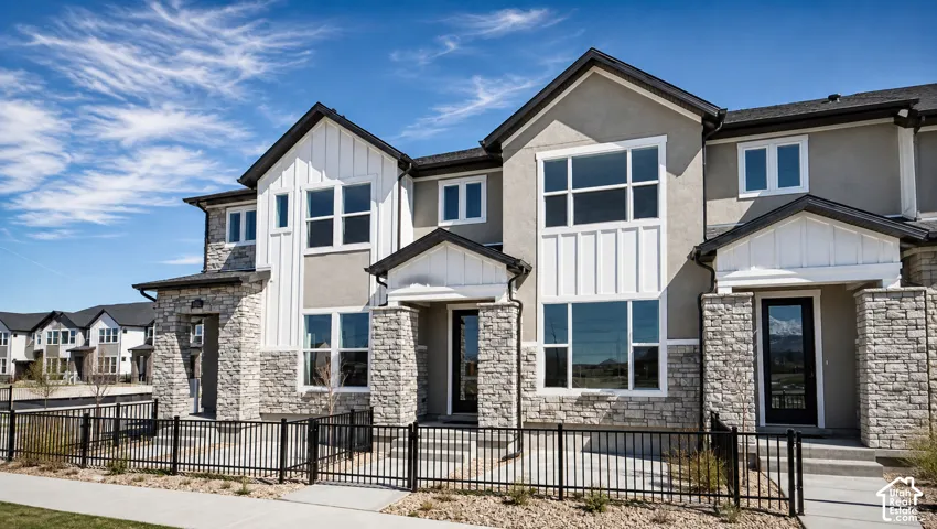 Contemporary exterior featuring a stone and stucco facade