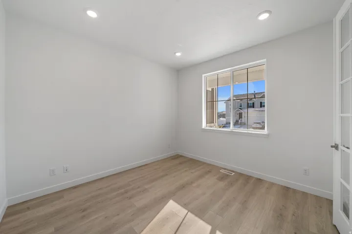 Spare room featuring light wood finished floors and recessed lighting