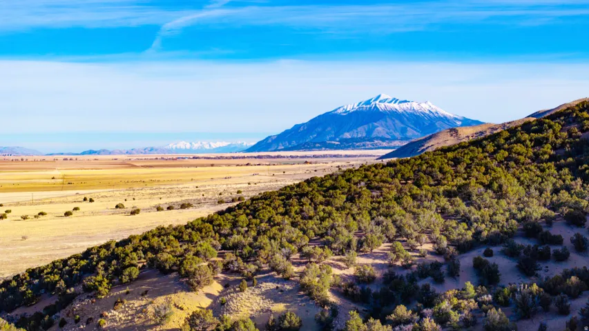 View of mountain backdrop with rural landscape