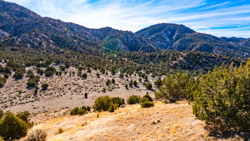 View of mountain backdrop with rural landscape