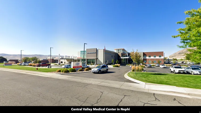 View of asphalt street featuring a mountain view and curbs