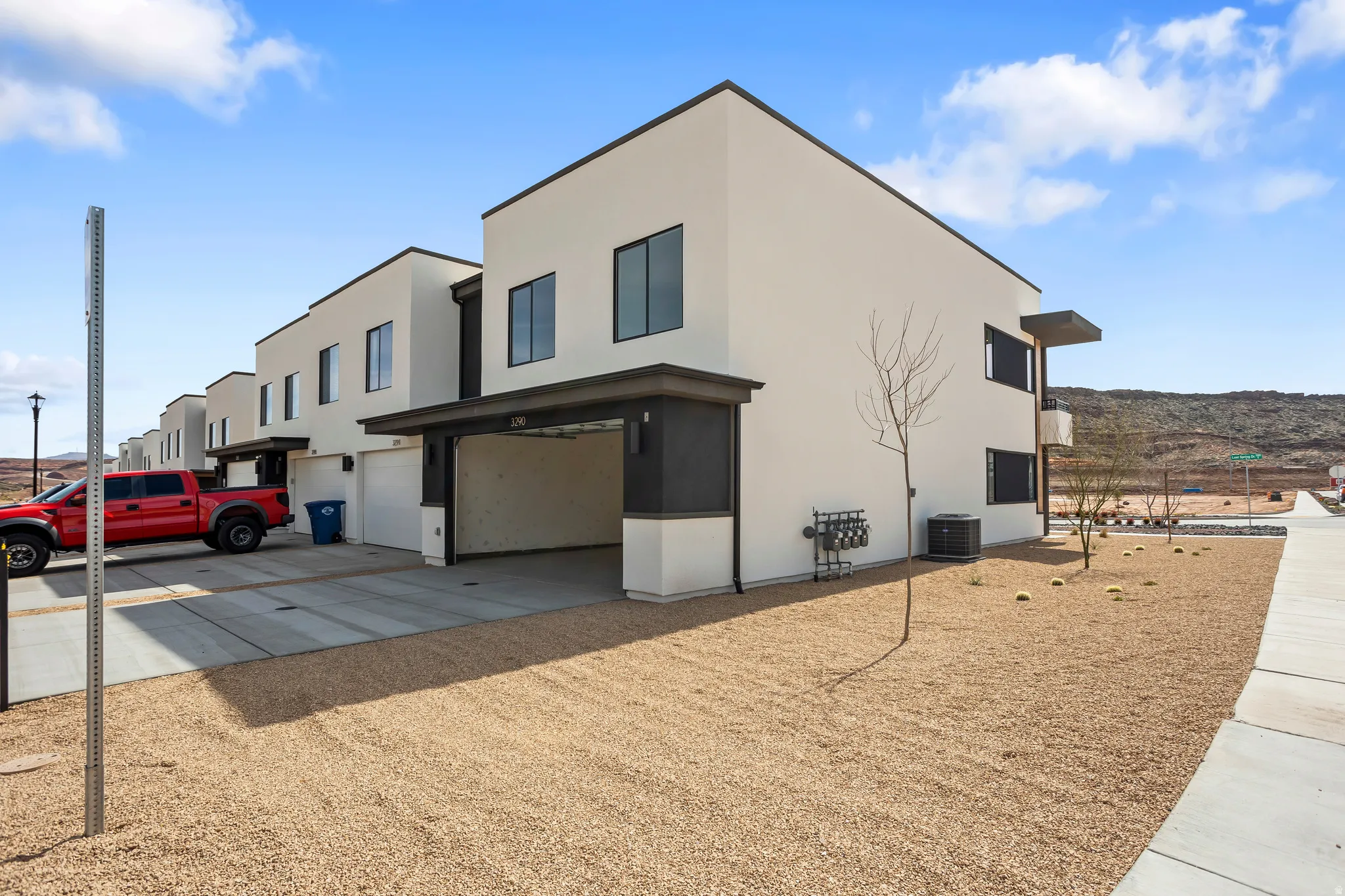 View of home's exterior with stucco siding, an attached garage, and driveway