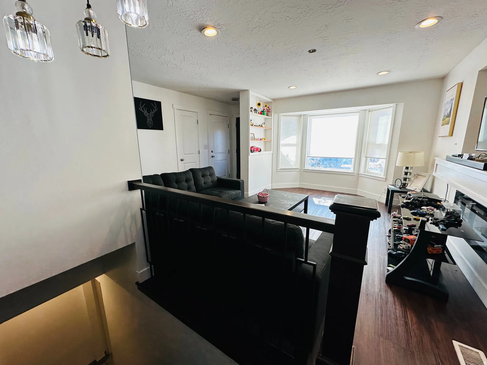 Kitchen with a textured ceiling, dark wood-type flooring, a fireplace, and recessed lighting