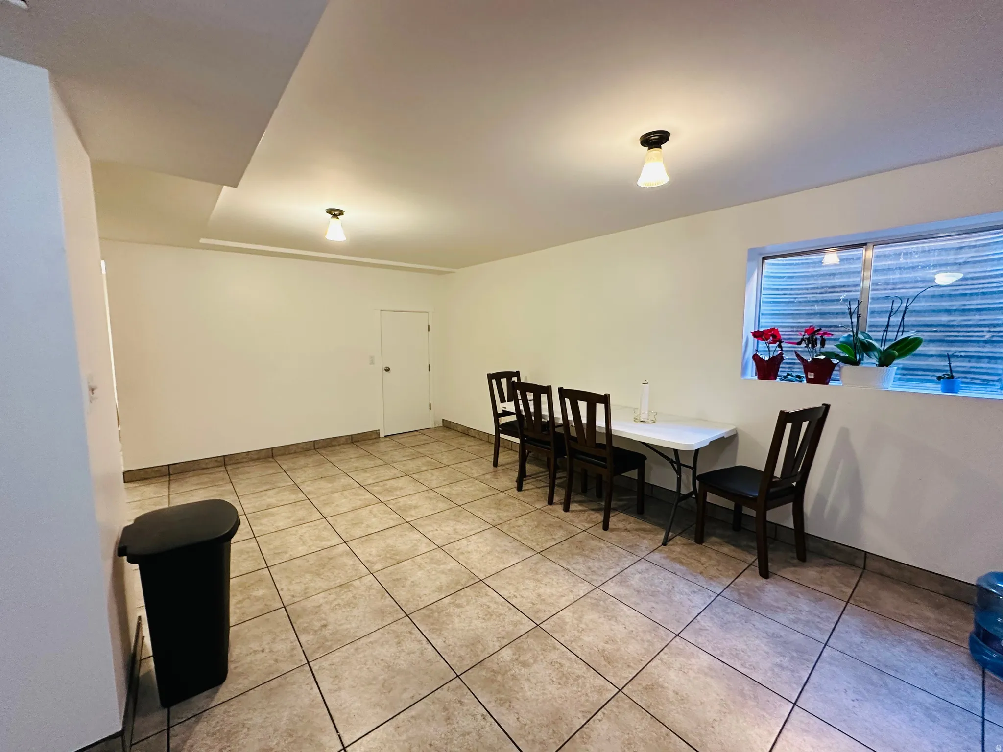 Dining room with light tile patterned flooring and baseboards