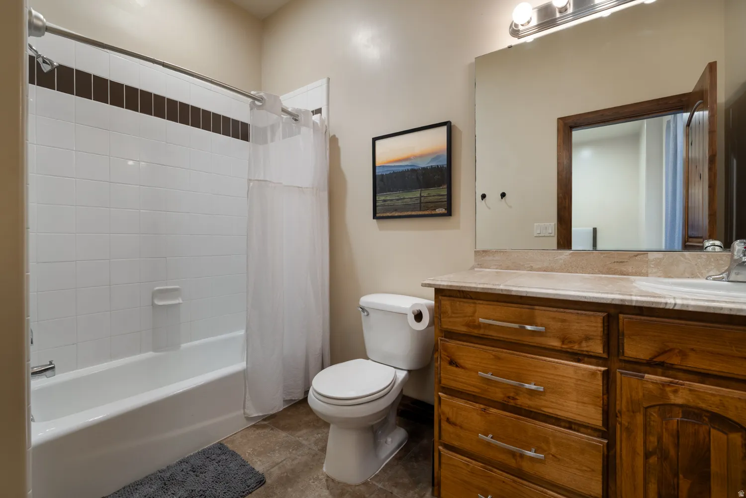 Bathroom featuring vanity and shower / bath combo with shower curtain