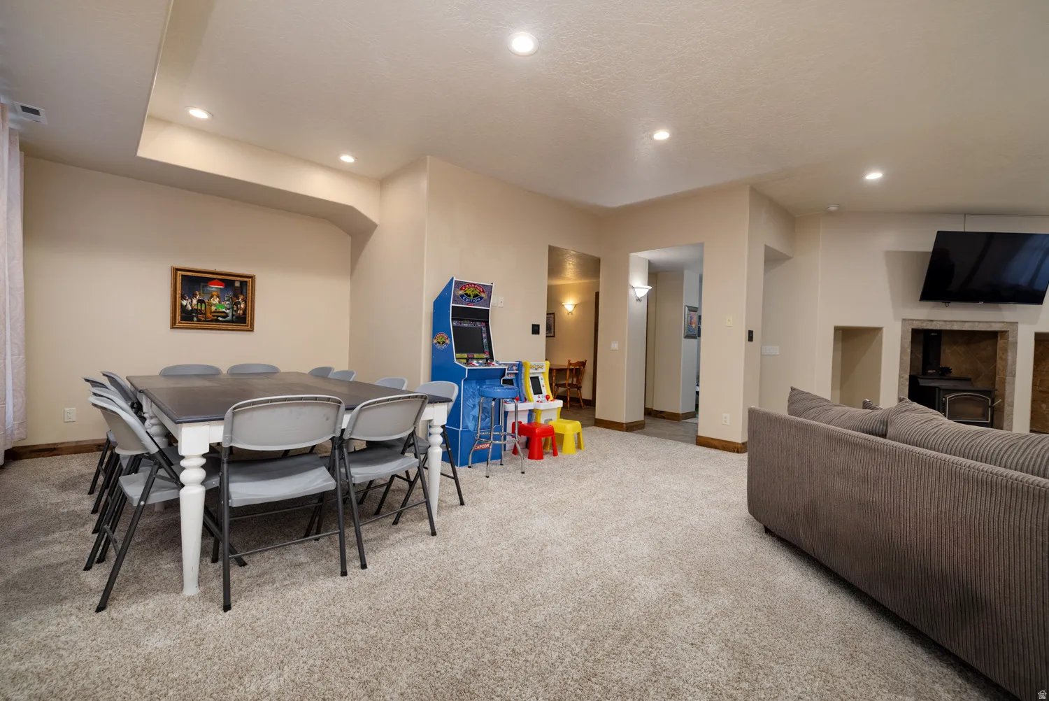 Dining room with light colored carpet and recessed lighting