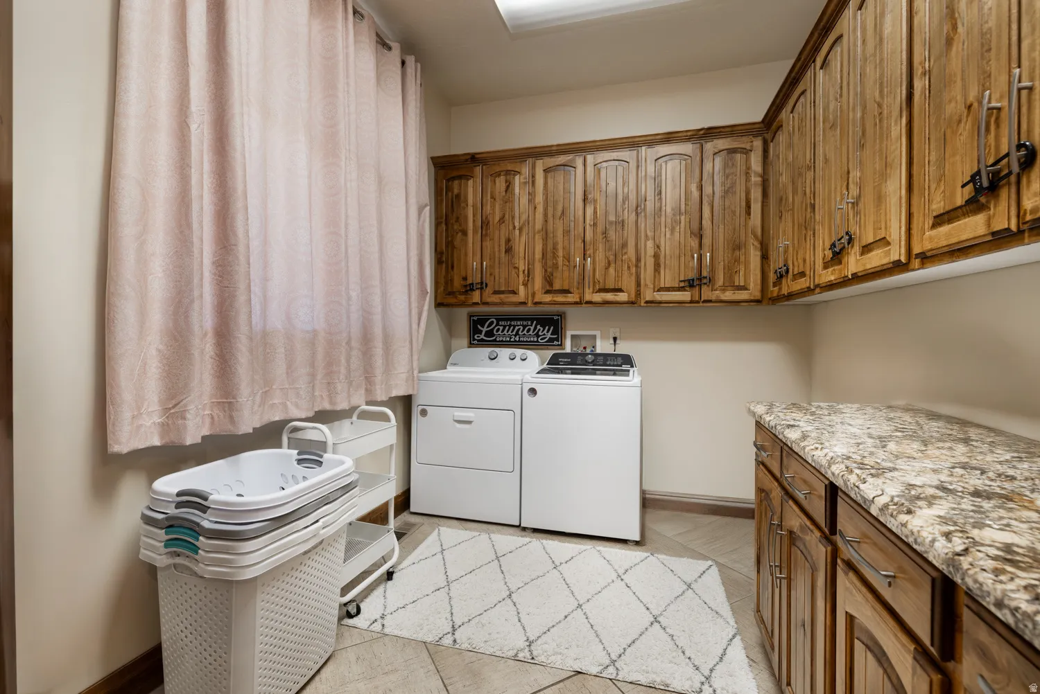 Laundry area with cabinet space and washer and clothes dryer