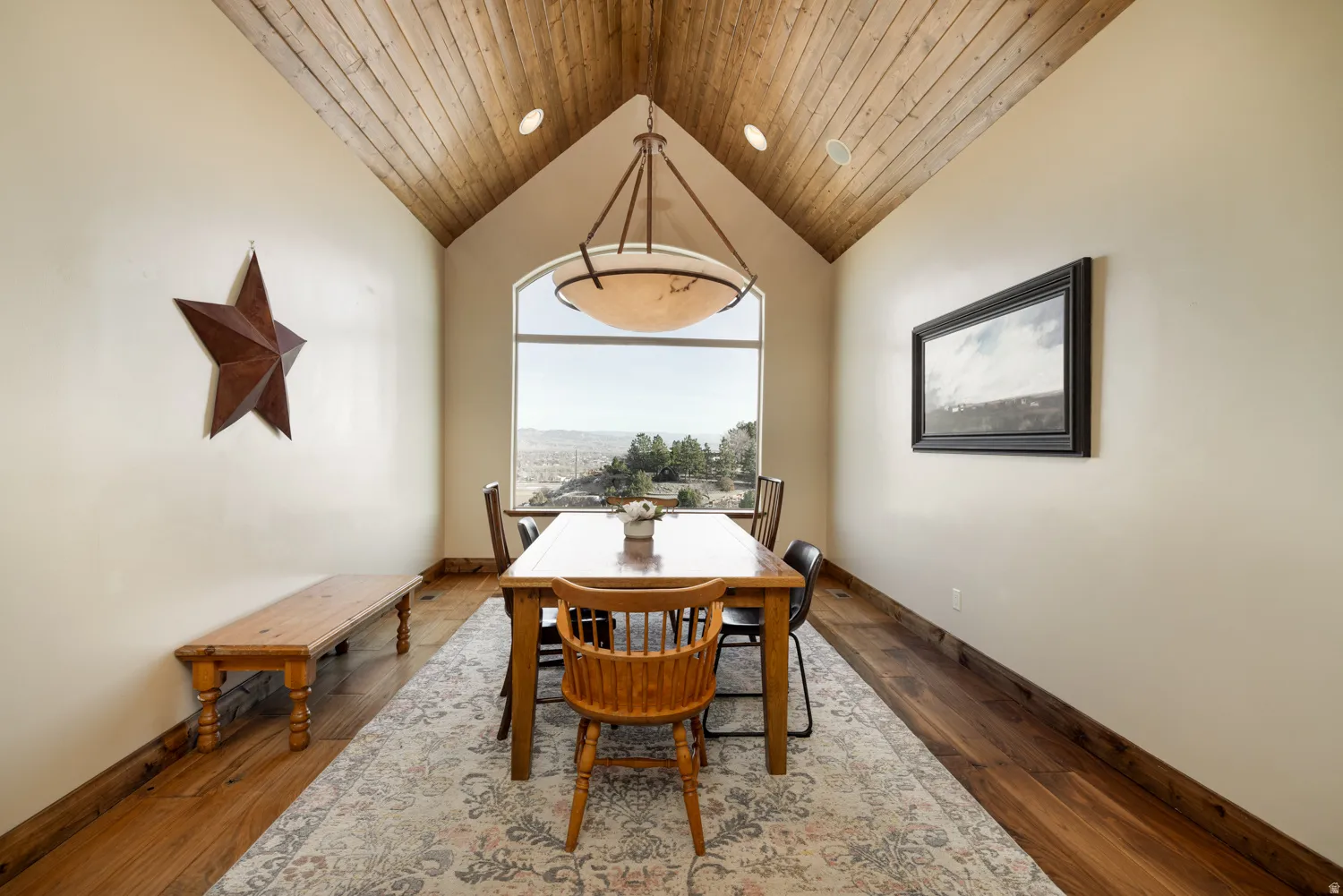 Dining room with a high wooden ceiling and dark wood-style flooring
