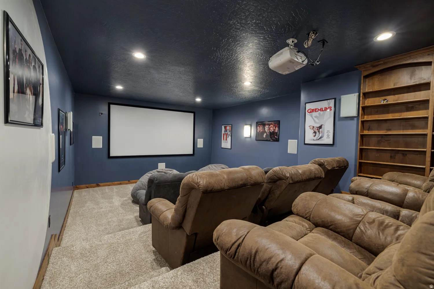 Home theater with recessed lighting, carpet floors, and a textured ceiling