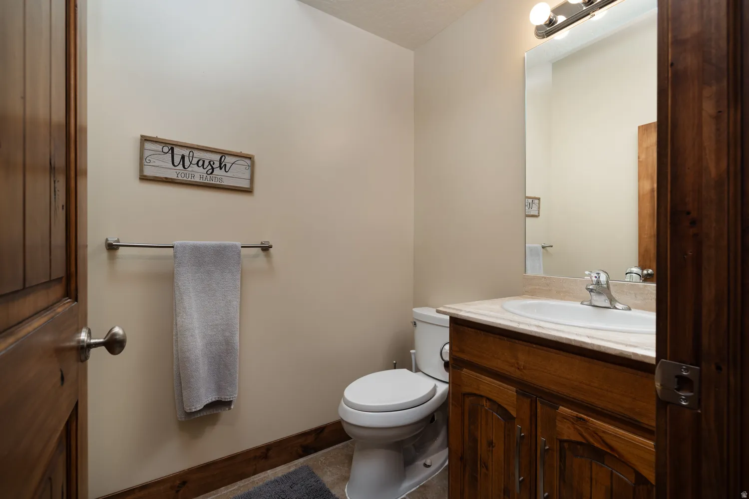 Half bathroom featuring vanity and toilet