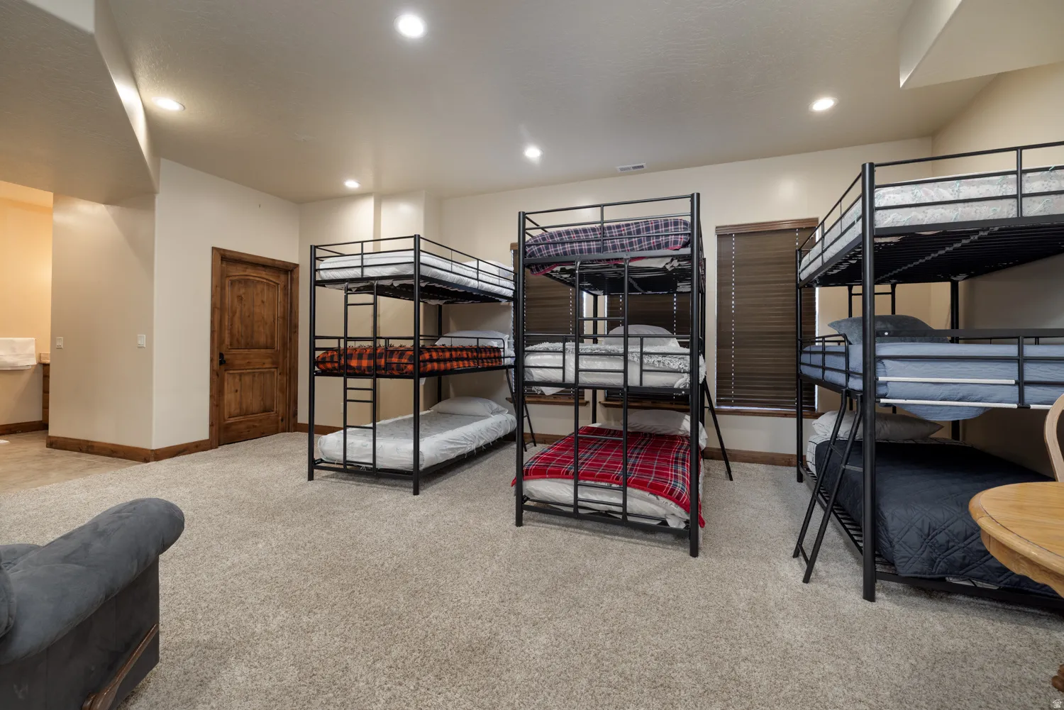 Bedroom with light colored carpet and recessed lighting