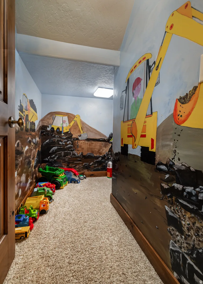 Carpeted bedroom featuring a textured ceiling