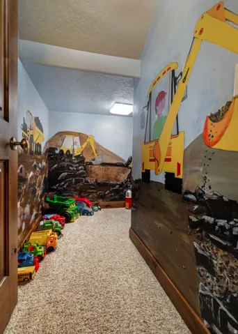 Carpeted bedroom featuring a textured ceiling