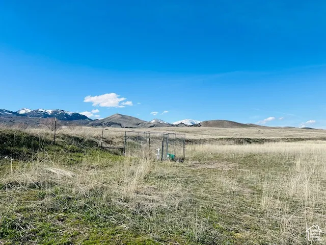 View of mountain backdrop featuring rural landscape