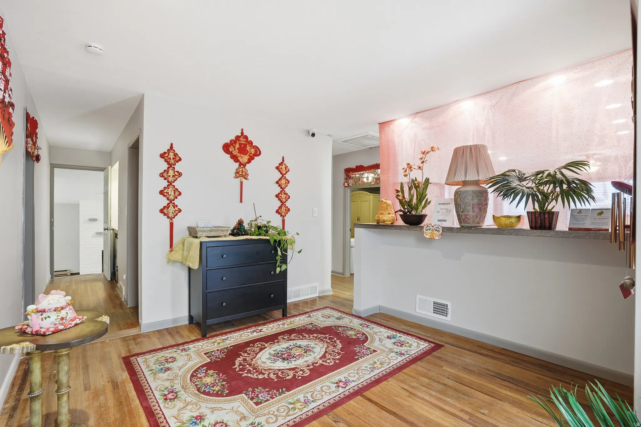 Living area with light wood-style flooring and baseboards