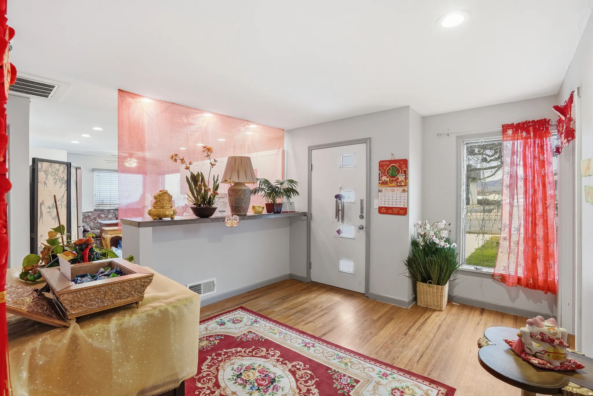 Entryway with wood finished floors and recessed lighting
