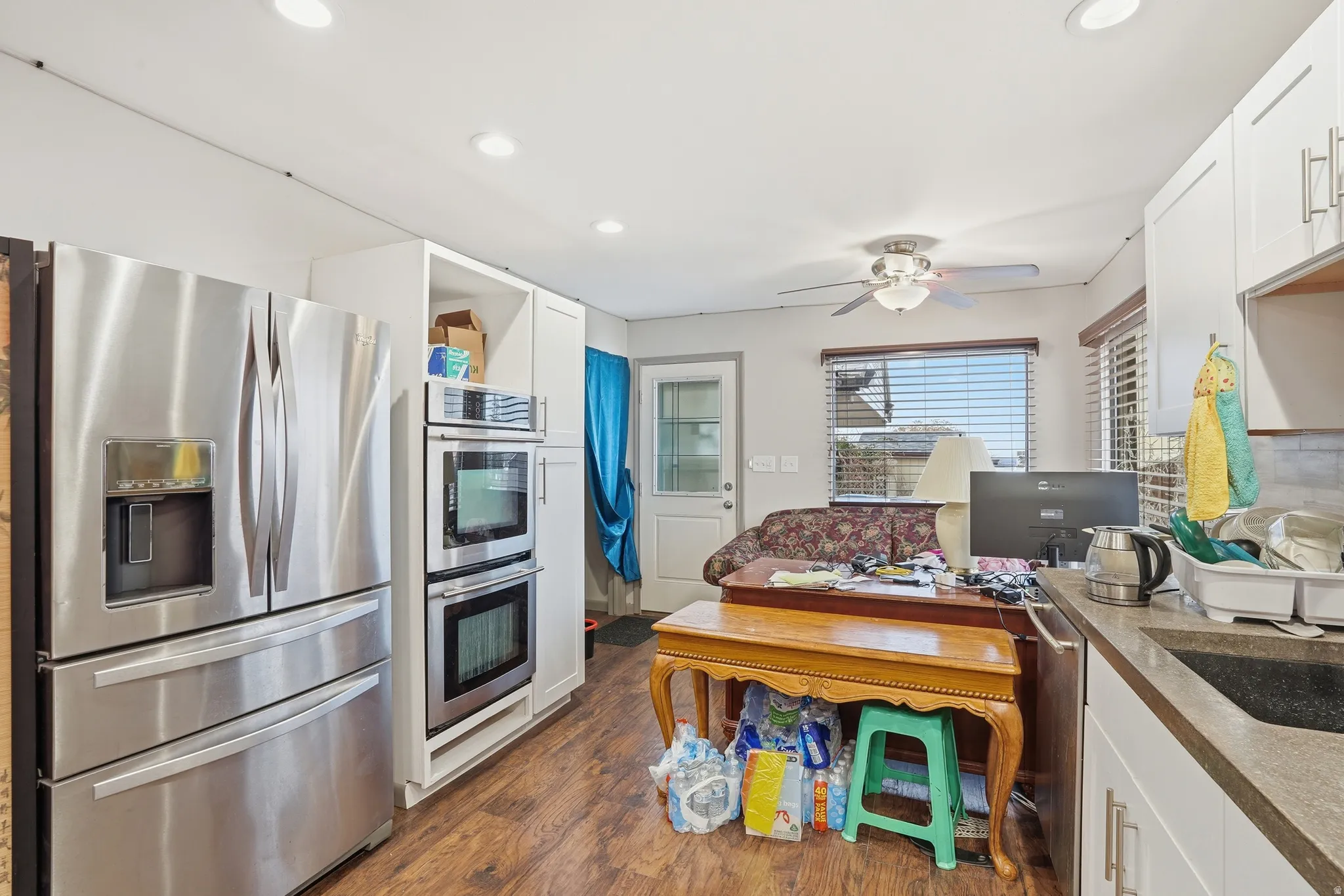 Kitchen featuring stainless steel appliances, white cabinets, dark wood-style floors, recessed lighting, and ceiling fan