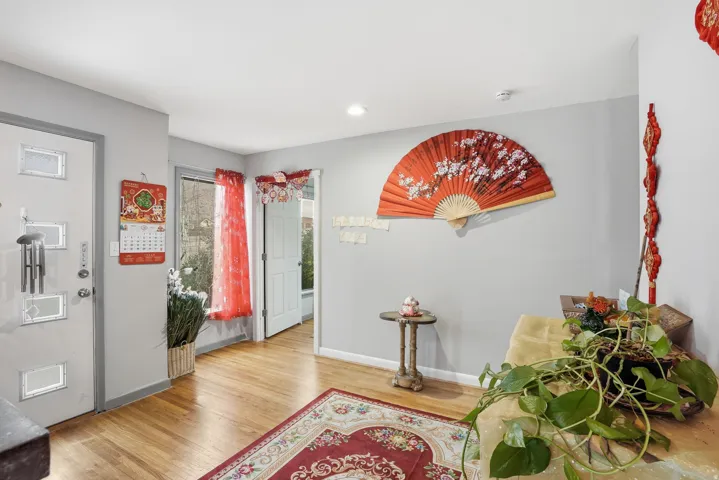 Entrance foyer featuring light wood-type flooring and baseboards