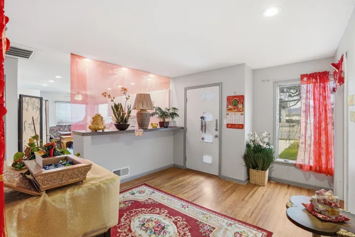 Entryway with wood finished floors and recessed lighting