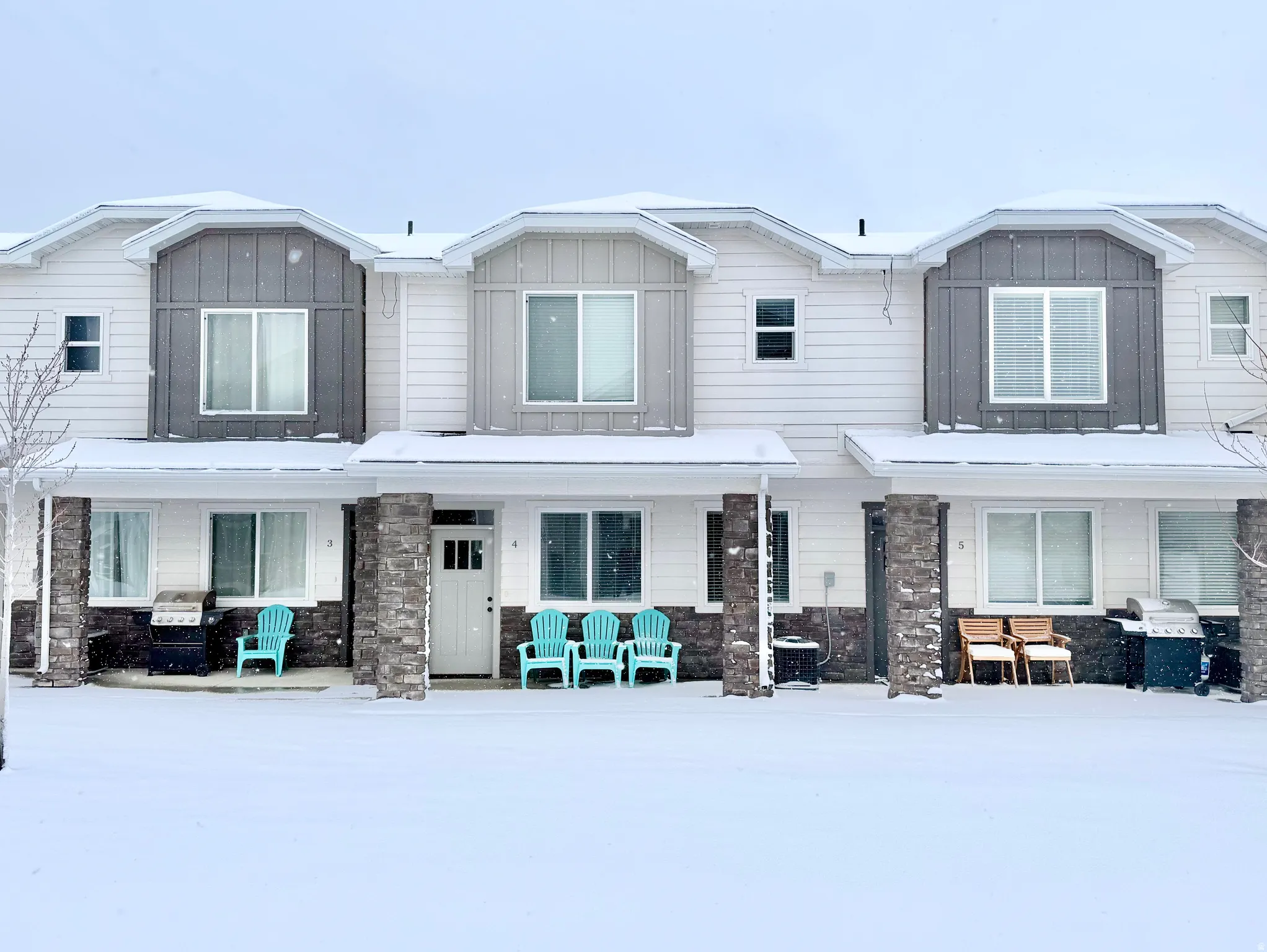 View of front of house featuring stone siding, board and batten siding, and covered porch