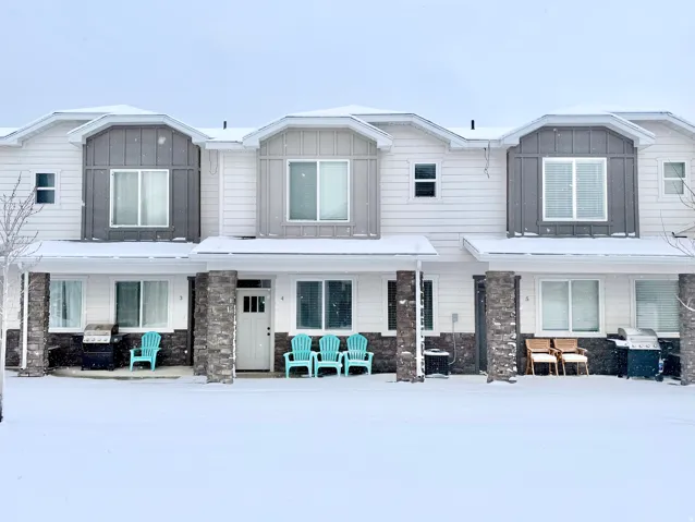 View of front of house featuring stone siding, board and batten siding, and covered porch
