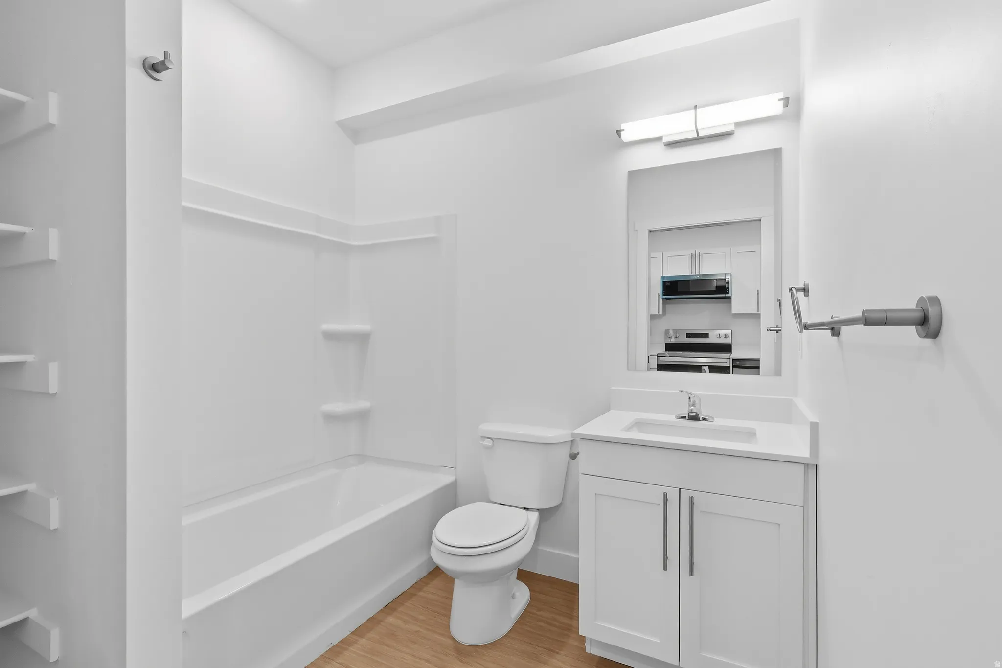 Full bathroom featuring vanity, light wood finished floors, and bathtub / shower combination