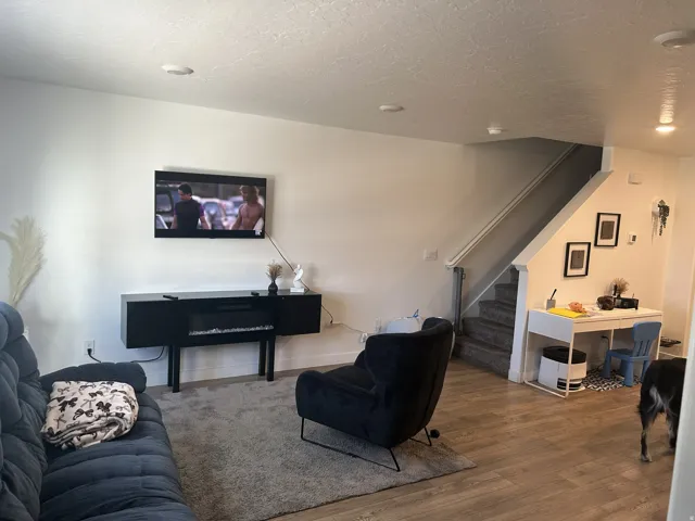 Living room with wood finished floors and a textured ceiling