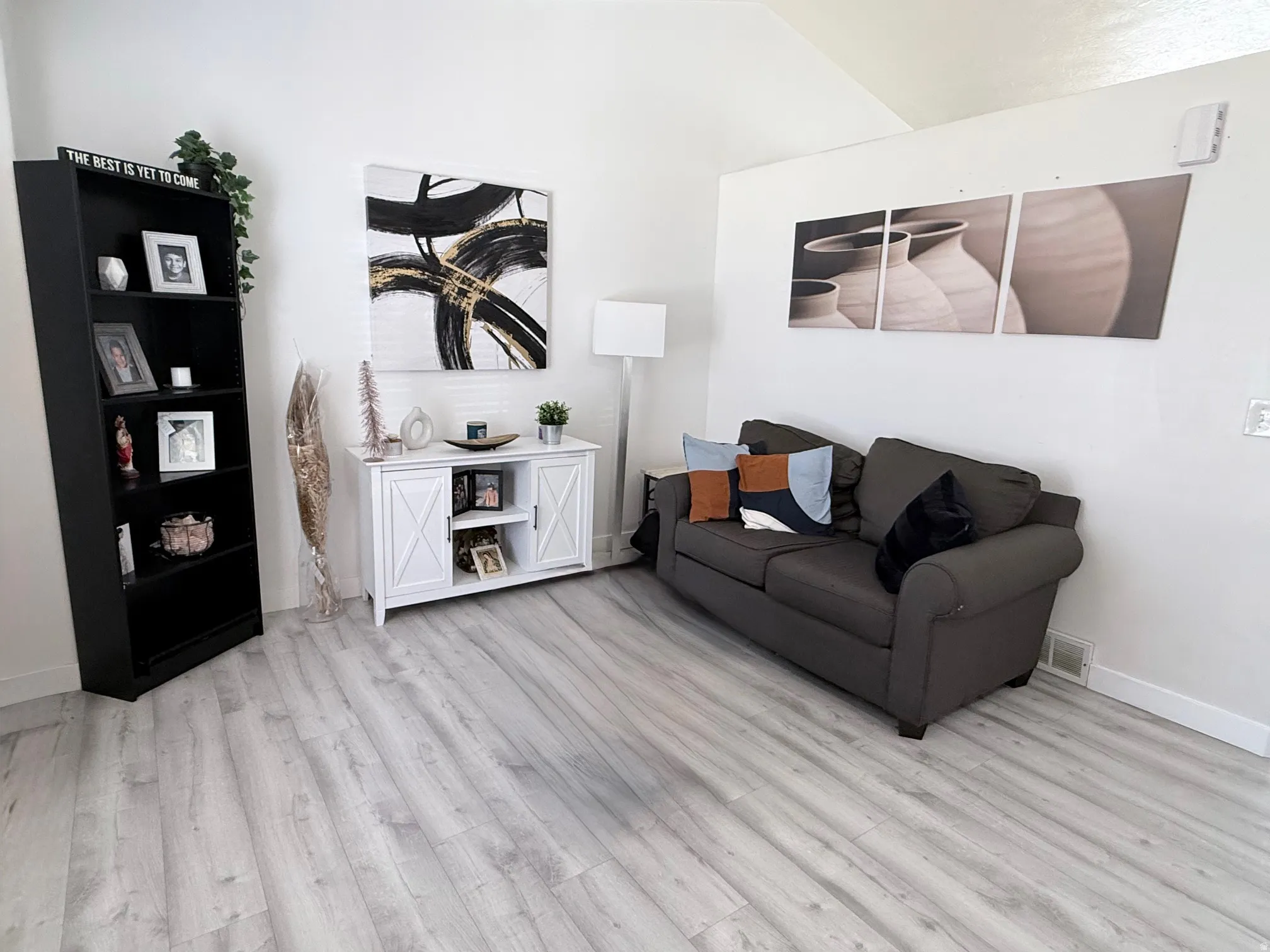 Living area featuring light wood-style floors and lofted ceiling