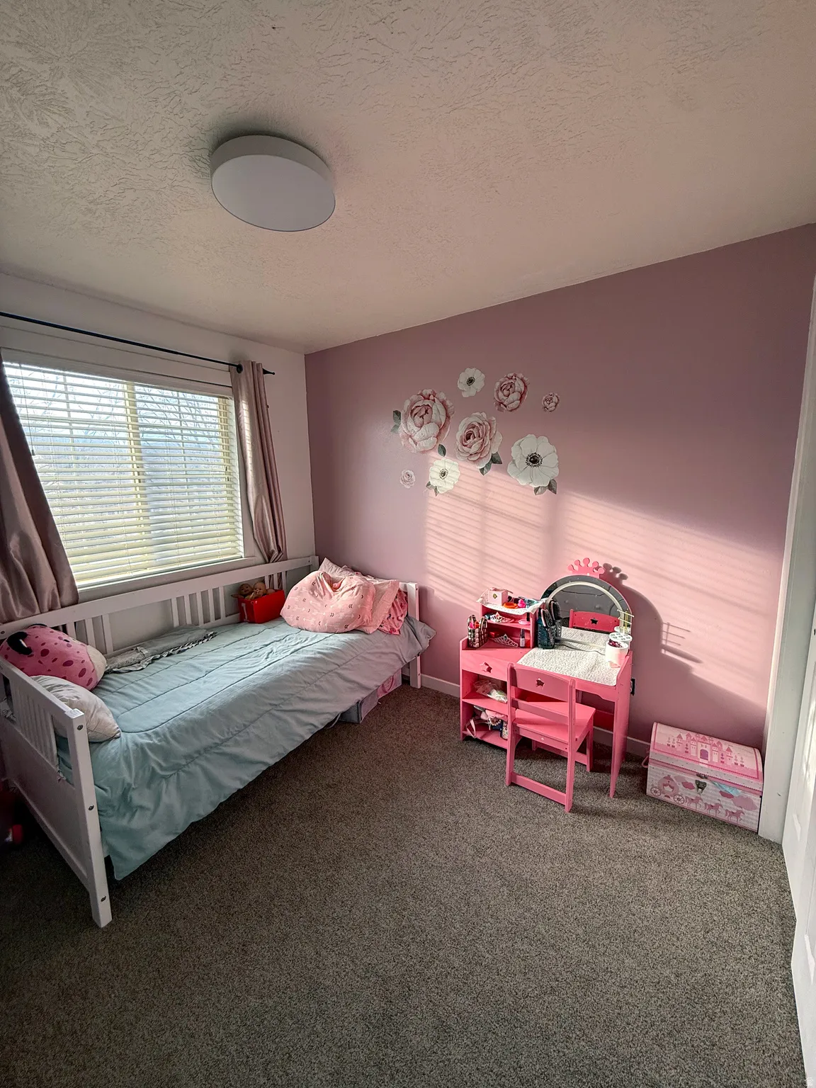 Carpeted bedroom with a textured ceiling
