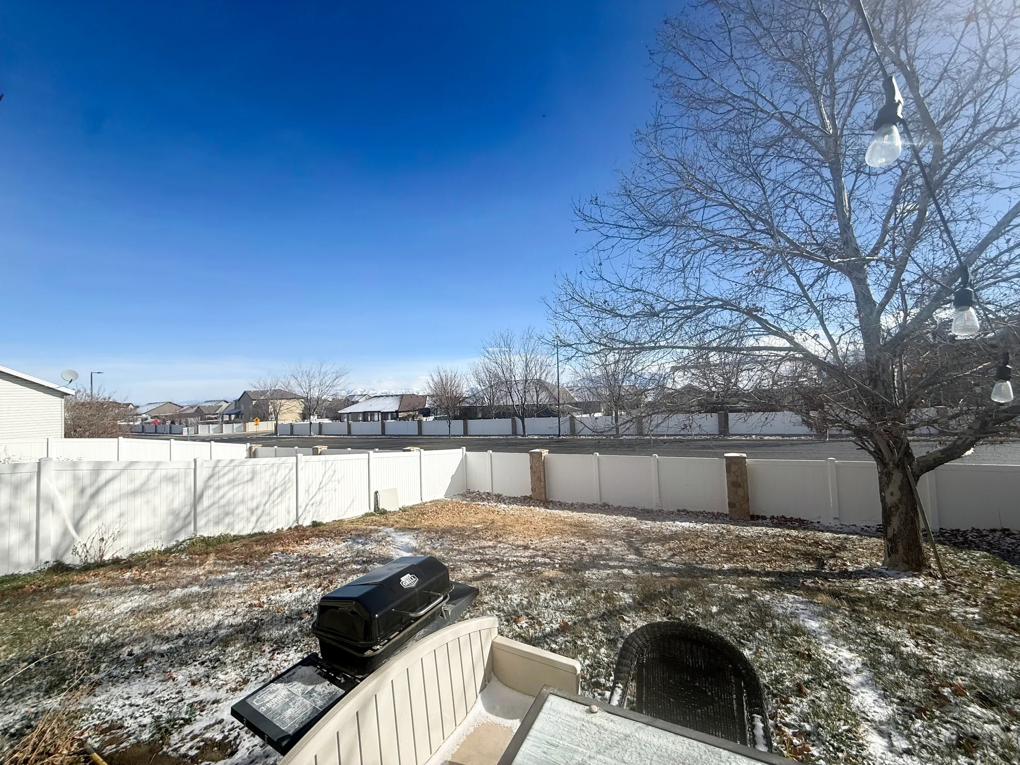Fenced backyard with a residential view
